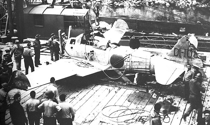 An Imperial Japanese Navy Zero fighter that crashed on Akutan Island, Alaska on June 4, 1942 is loaded onto a ship by U.S. military forces for shipment to Seattle, Washington in July 1942. The Zero was later used for int