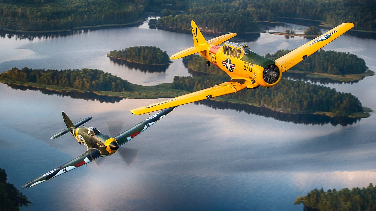 Finnish Air Force Hawker Hurricane warbird and T-6 Texan warbird in flight over Finland.
