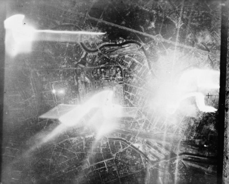 Royal Air Force Bomber Command, 1942-1945. Aerial vertical taken over the Moabit district of Berlin during a raid by 33 De Havilland Mosquitos of the Late Night Striking Force. The track of a falling target indicator (TI