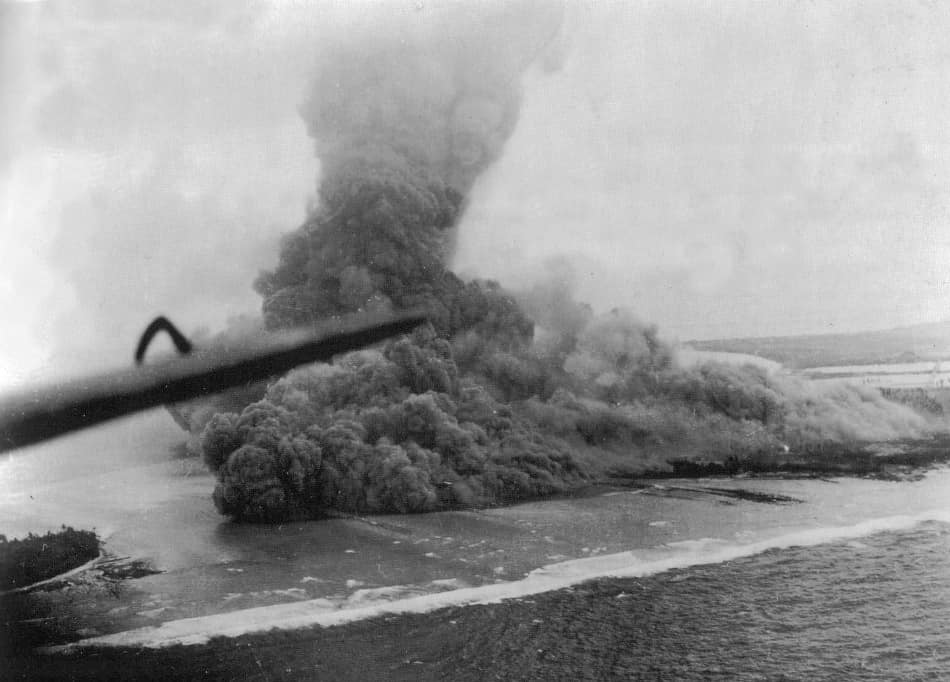Explosion of a torpedo warhead magazine on Namur, Kwajalein Atoll, at 1305 hrs, 1 February 1944, as seen from a U.S. Navy plane. A demolition team of F Company, 24th Marines, led by Lieutenant Saul Stein threw satchel ch