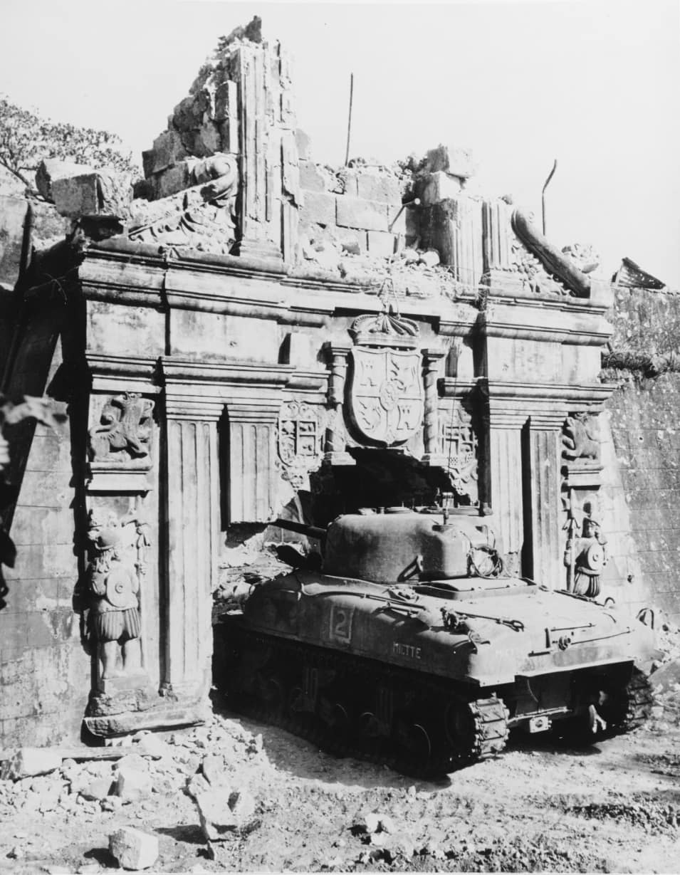 Battle of Manila a U.S. Army M4 Sherman tank enters old Fort Santiago through a somewhat enlarged gate, 26 February 1945. Note crest carved over the gate, and extensive damage.