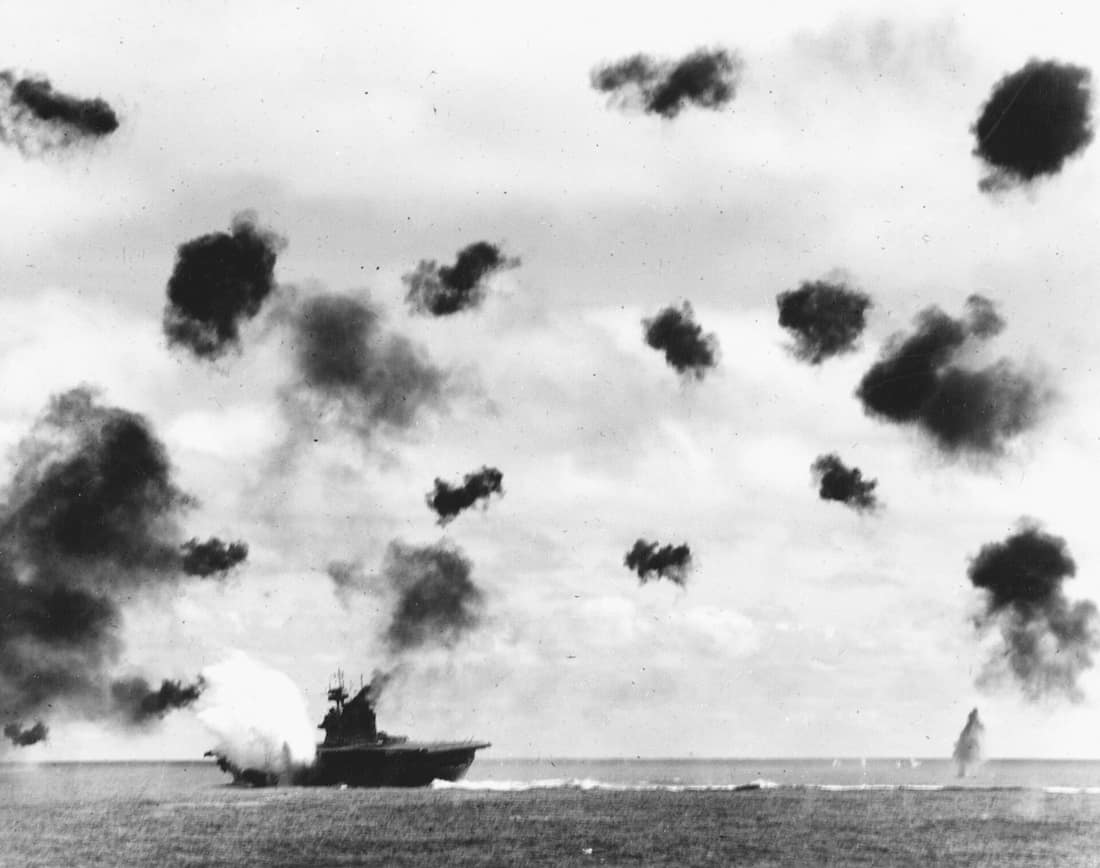 USS Yorktown (CV-5) is hit on the port side, amidships, by a Japanese Type 91 aerial torpedo during the mid-afternoon attack by planes from the carrier Hiryu, in the Battle of Midway, on 4 June, 1942. Yorktown is heeling
