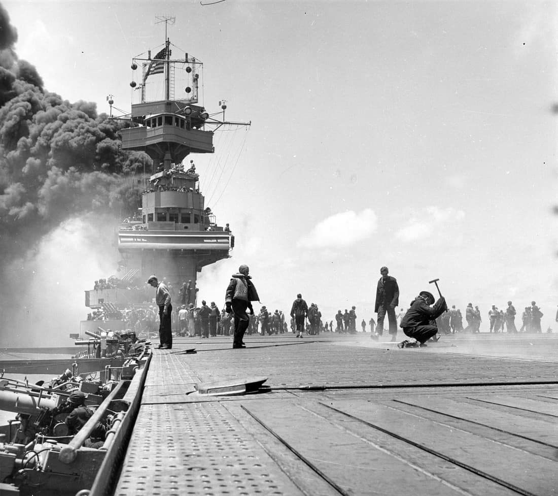 80-G-312018: Battle of Midway, June 1942. Scene on board USS Yorktown (CV-5), shortly after she was hit by three Japanese bombs on 4 June 1942. Dense smoke is from fires in her uptakes, caused by a bomb that punctured th