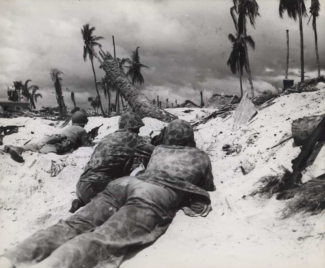 "On Tarawa Beach-Marines landing on Tarawa Island beach creep up on Jap pill boxes. The terrain of the island offered very little protective covering but these Marines made use of what little covering there was. Some of 