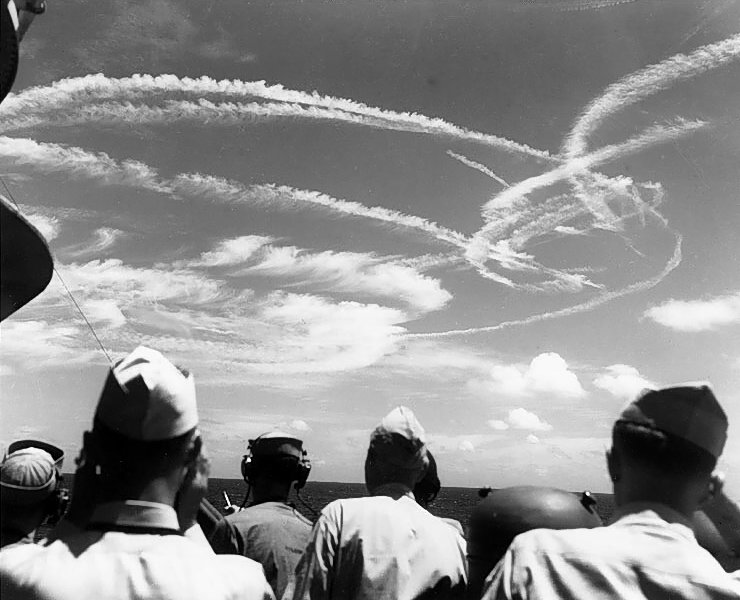 Fighter plane contrails mark the sky over Task Force 58, during the "Great Marianas Turkey Shoot" phase of the battle, 19 June 1944. Photographed from on board USS Birmingham (CL-62). (Battle of the Philippine Sea, June 