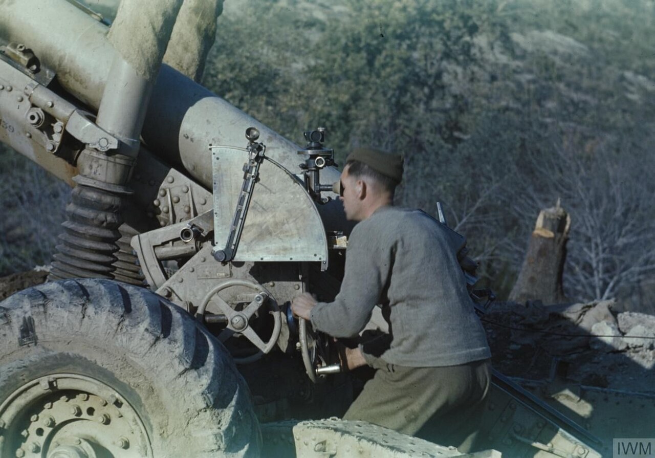 A 5.5 Inch Gun Crew on the Italian Front, 10 January 1944 Gunner Kelford, of Buckley, Chester, the gun layer, at the 5.5 inch gun, near Sessa Aurunca, Garigliano River Valley, Italy.