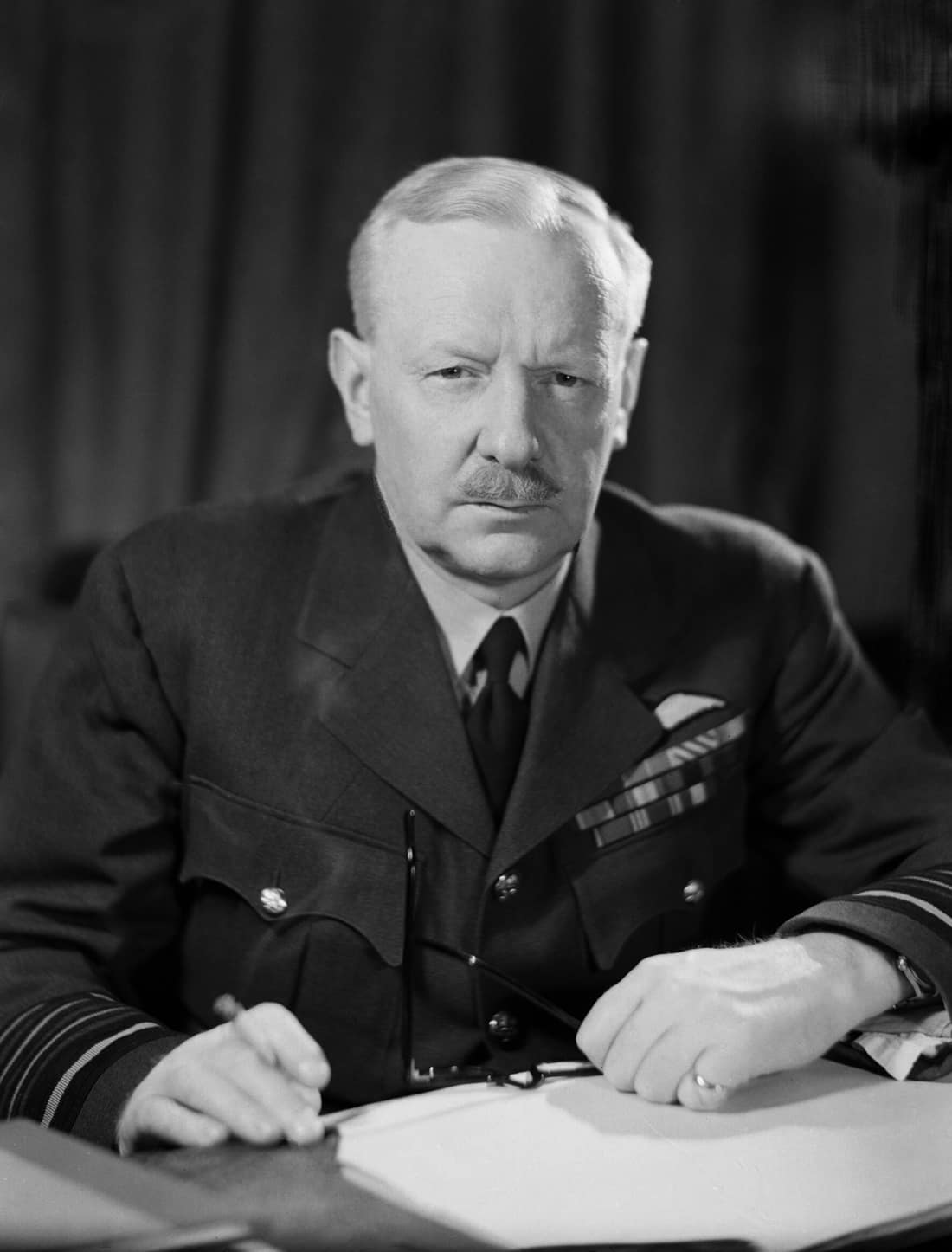 Air Chief Marshal Sir Arthur Harris, Commander in Chief of Royal Air Force Bomber Command, seated at his desk at Bomber Command HQ, High Wycombe.
