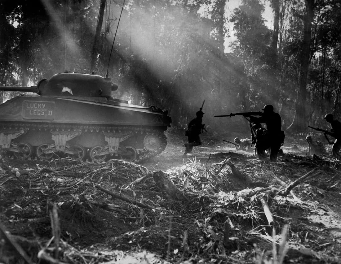 U.S. Army soldiers on Bougainville (one of the Solomon Islands) in World War II. Japanese forces tried infiltrating the U.S. lines at night; at dawn, the U.S. soldiers would clear them out. In this picture, infantrymen a