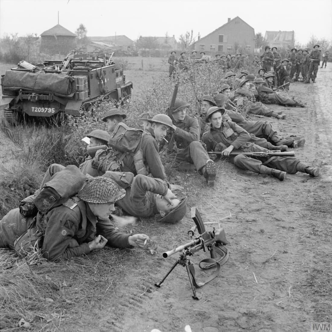 Infantry and carriers of 8th Royal Scots pause during the attack by 15th (Scottish) Division on Tilburg, 27 October 1944.