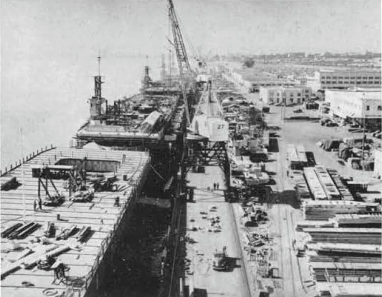 U.S. Navy escort carriers fitting out at Kaiser Shipyards, Vancouver, Washington (USA), in April-May 1944. One of the carriers is USS Lunga Point (CVE-94).
