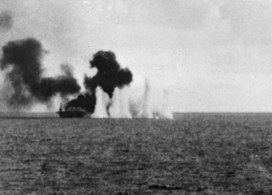 The U.S. Navy escort carrier USS Gambier Bay (CVE-73) is straddled by fire from Japanese surface ships during the Battle off Samar.