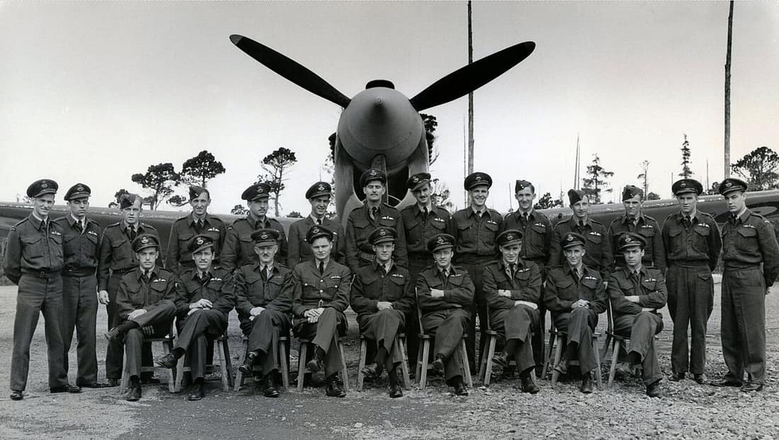 118 Sqn RCAF pilots at Sea Island BC 1943 in front of a unit Kittyhawk. Standing left to right: Ward, Park, Vickers, Dawber, Price, Getty, Hutchinson, Jones, Edington, Hilton, Hope, Upham, Coffey, McKenzie. Sitting left 