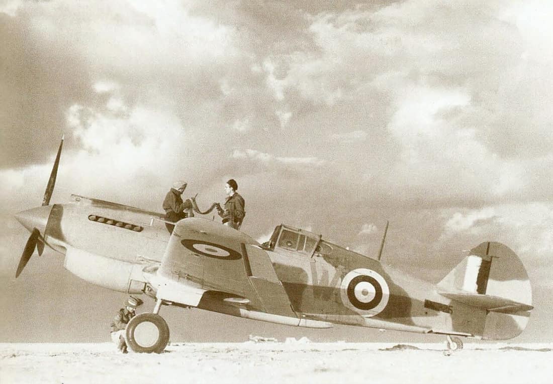 Western Desert, North Africa. 1941-12-23. Armourers working on a Tomahawk fighter aircraft of No 3 Squadron RAAF.