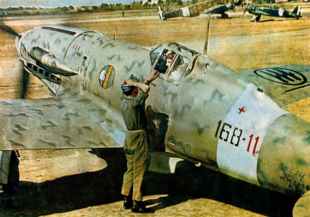 Macchi C.202. Likely a squadron PR photo from 1942–1943 (prior to the Armistice). Author unknown. Photo found on: http://www.ww2incolor.com/gallery/other/italian_1943 Per below, Italian copyright expired in the 1960s, th