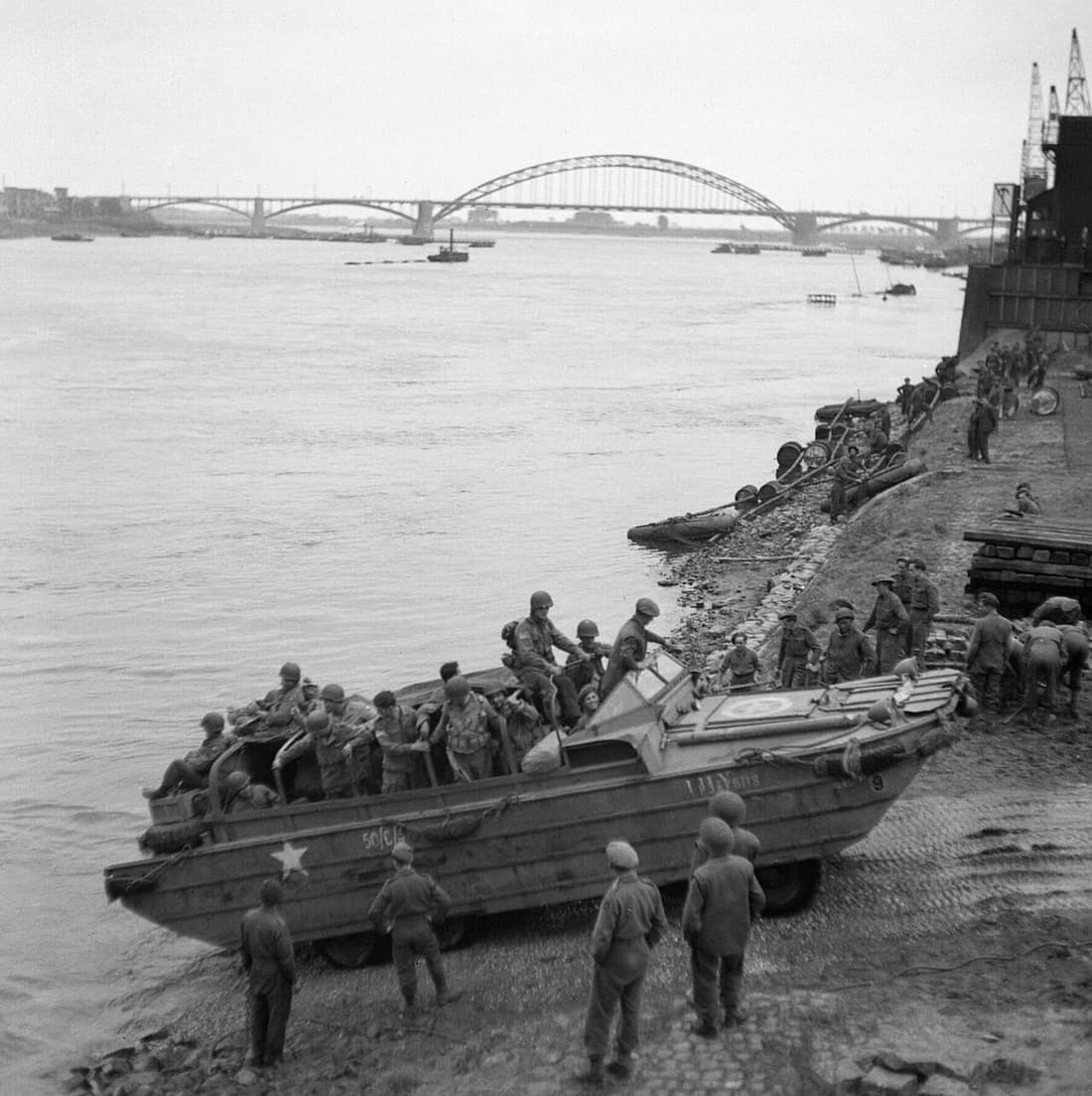 A British DUKW carries supplies and American paratroopers across the Waal river at Nijmegen, 30 September 1944. A British DUKW carries supplies and American paratroopers across the Waal river at Nijmegen, 30 September 19