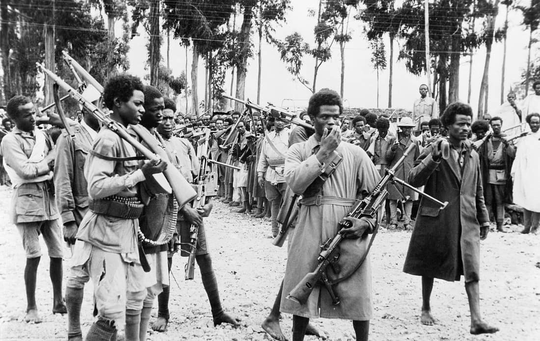 Ethiopian men gather in Addis Ababa, heavily armed with captured Italian weapons, to hear the proclamation announcing the return to the capital of the Emperor Haile Selassie in May 1941. Ethiopian men gather in Addis Aba