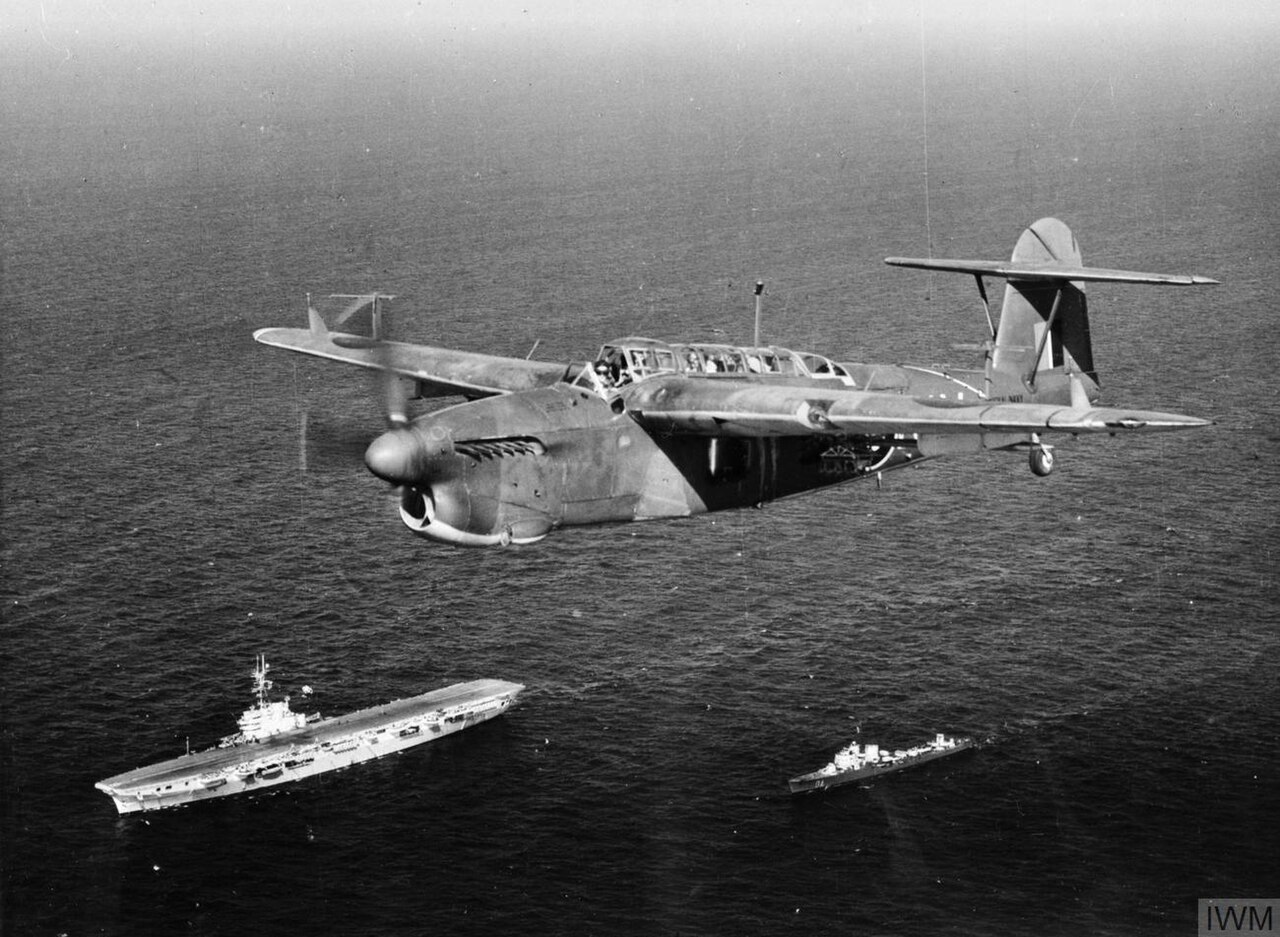 A Fairey Barracuda II of 814 Squadron, Fleet Air Arm flying over HMS Venerable and an attendant destroyer, the Italian ALFREDO ORIANI.