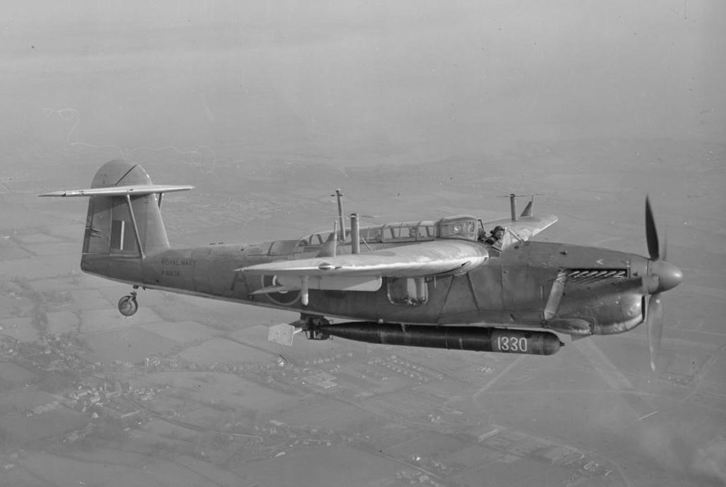 A Royal Navy Fairey Barracuda II (s/n P9926) from Lee-on-Solent Fleet Air Arm Station, Hampshire (UK), with torpedo, in flight. The wooden plane that steadied the torpedo before it struck the water and broke off can be c