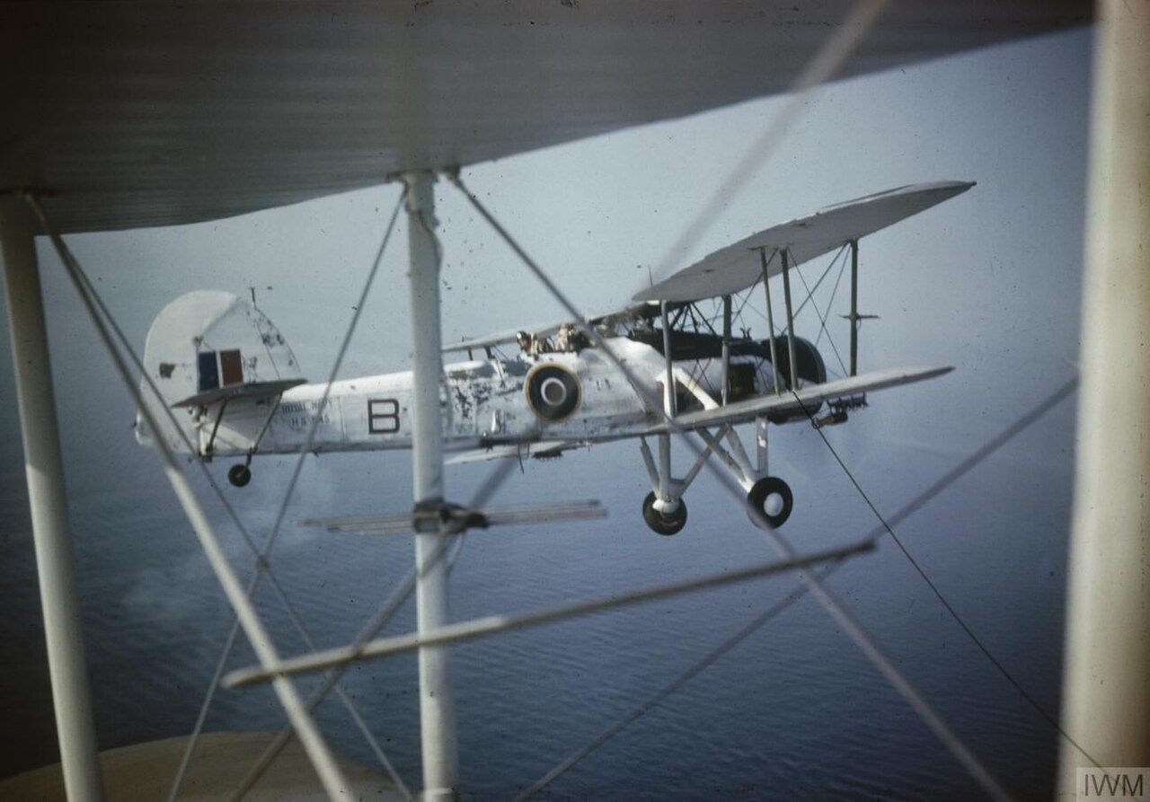 A Fairey Swordfish in Flight Close-up of a Fairey Swordfish Mark II, HS 545 'B', in flight as seen through the struts of another aircraft, probably while serving with No 824 Squadron, Fleet Air Arm, 1943-1944.