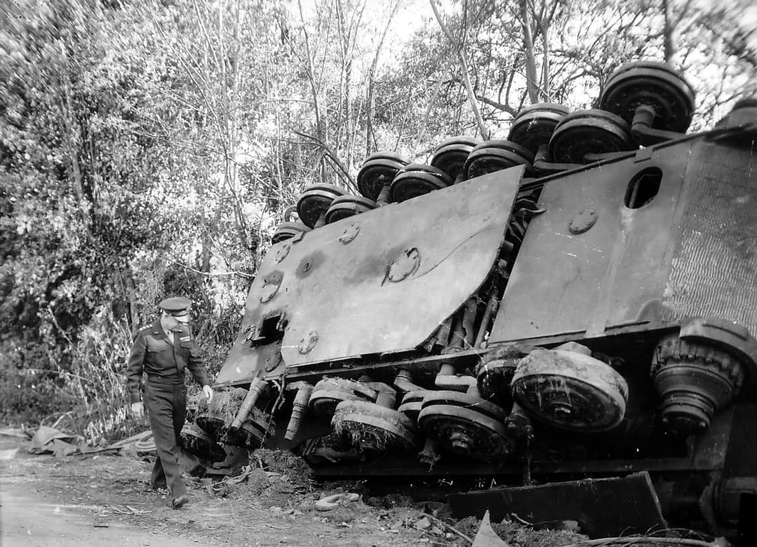 “IKE” INSPECTS THE WORK OF HIS MEN FRANCE – Gen. Dwight D. Eisenhower, supreme commander of the Allied expeditionary forces, inspects an overturned German tank left by a roadside in France by the retreating enemy.