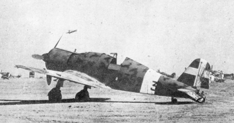 An Italian Fiat G.50 captured by the British at Sidi Rezegh airfield in North Africa.Note the RAF Hawker Hurricane landing, and another just visible above the rear deck of the G.50.A second G.50 can be seen just behind t