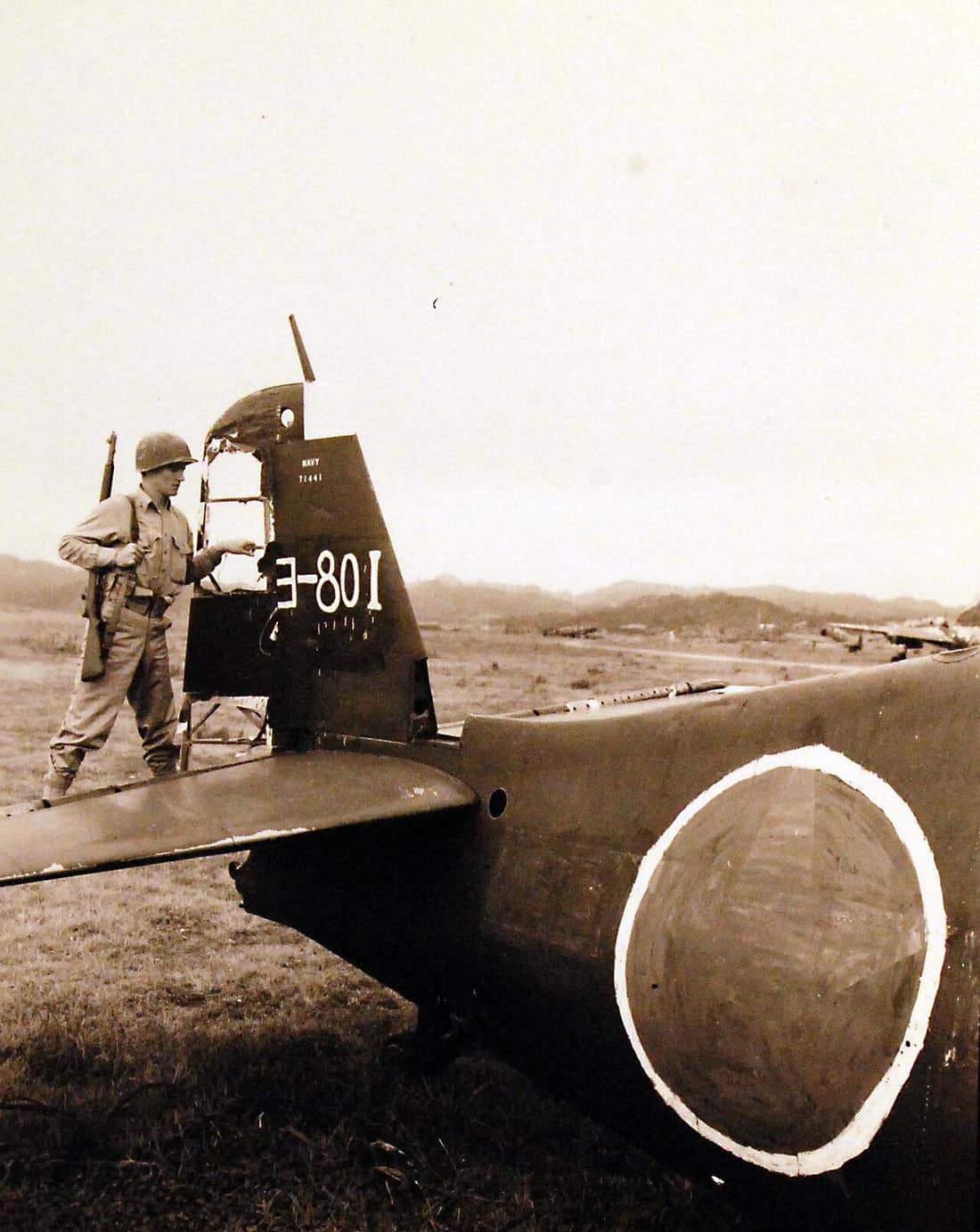 127-GW-1627-134956: Occupation of Japan, 1945. Surprise find to Marines of Marine Air Group 31, who flew up from Okinawa to occupy Yokosuka Naval Air Base 30 miles from Tokyo was this wrecked Grumman “Hellcat” fighter pl