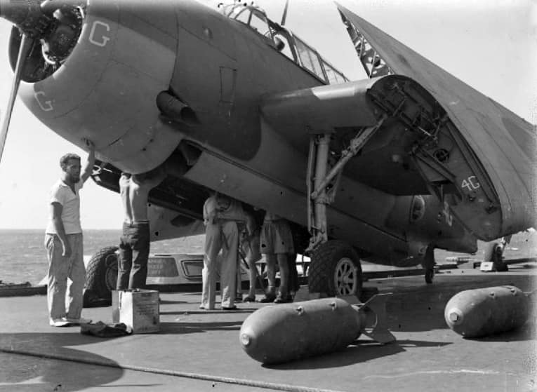 Bombing up a Royal Navy Grumman Avenger Mk.II aircraft of 832 or 845 Naval Air Squadron on the flight deck of the aircraft carrier HMS Illustrious (87) sailing in the Indian Ocean in readiness for the raid on Soerabaya, 