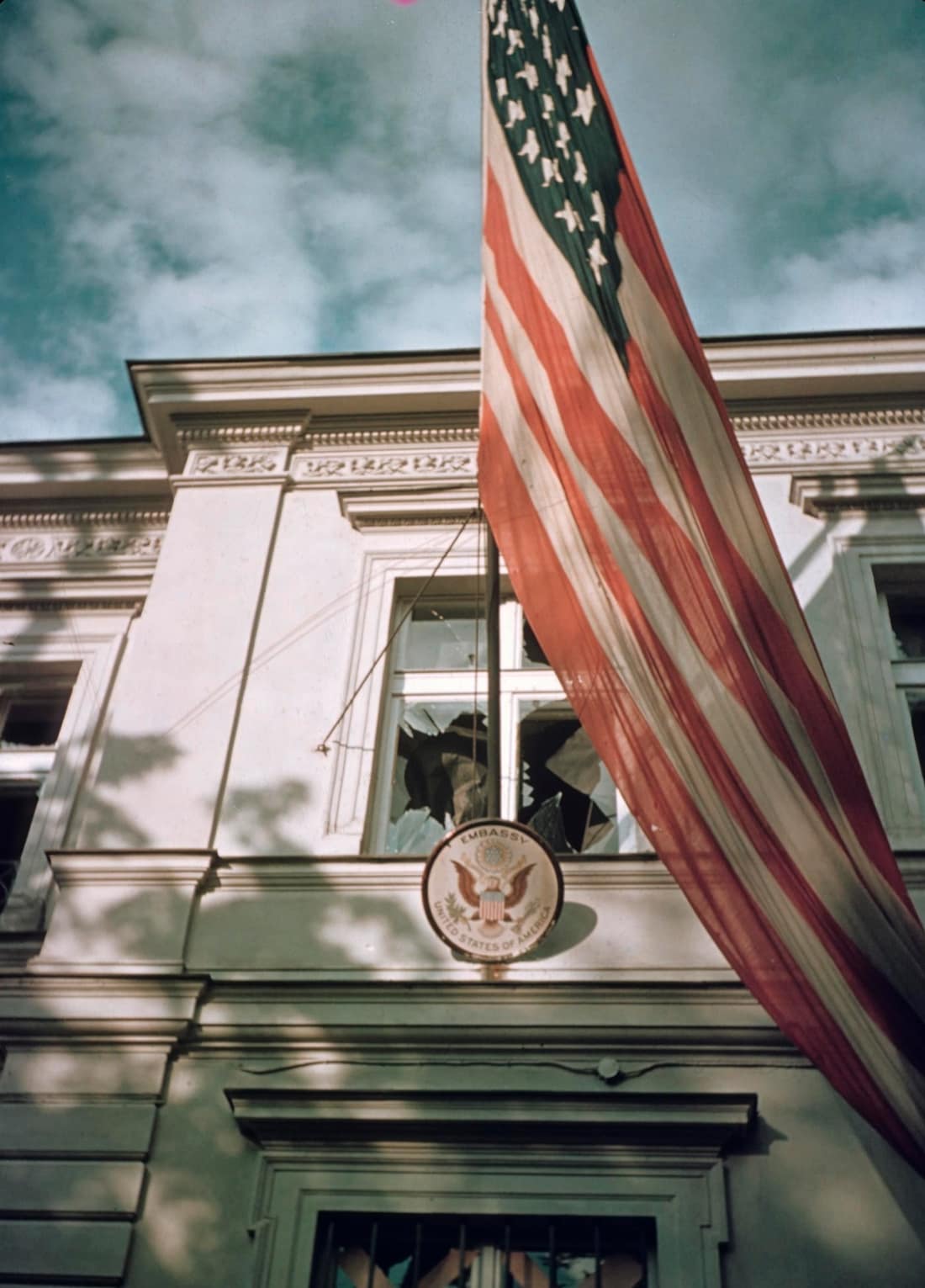 American Embassy in Warsaw during the siege of the capital of Poland in September 1939 by the German army. An American flag hangs outside the shattered window after the German air raid. One of the few Kodak Kodachrome ge