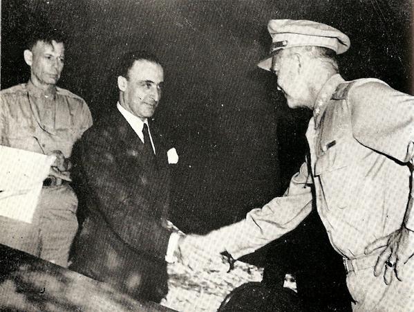 General Giuseppe Castellano (in civilian) shakes hands with Dwight D. Eisenhower after the signing of the Armistice between Italy and Allied armed forces in Cassibile on September 8, 1943. Major General Walter Bedell Smi