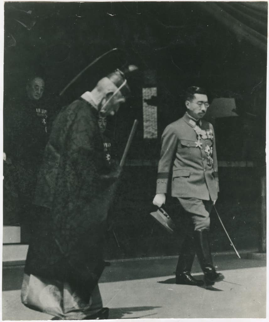 As the dreams of conquest vanish with the A-bomb destruction of Hiroshima and Nagasaki, Emperor Hirohito, sovereign of Japan, wearing his uniform for the last time, goes forth to announce the bitter news of surrender.
