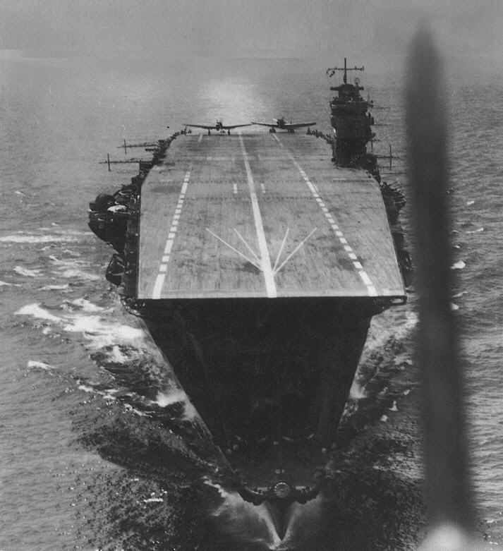 Japanese aircraft carrier Akagi in April, 1942 during the Indian Ocean Raid as seen from an aircraft that has just taken off from her deck. The aircraft on the flight deck preparing for takeoff are Aichi D3A Type 99 dive