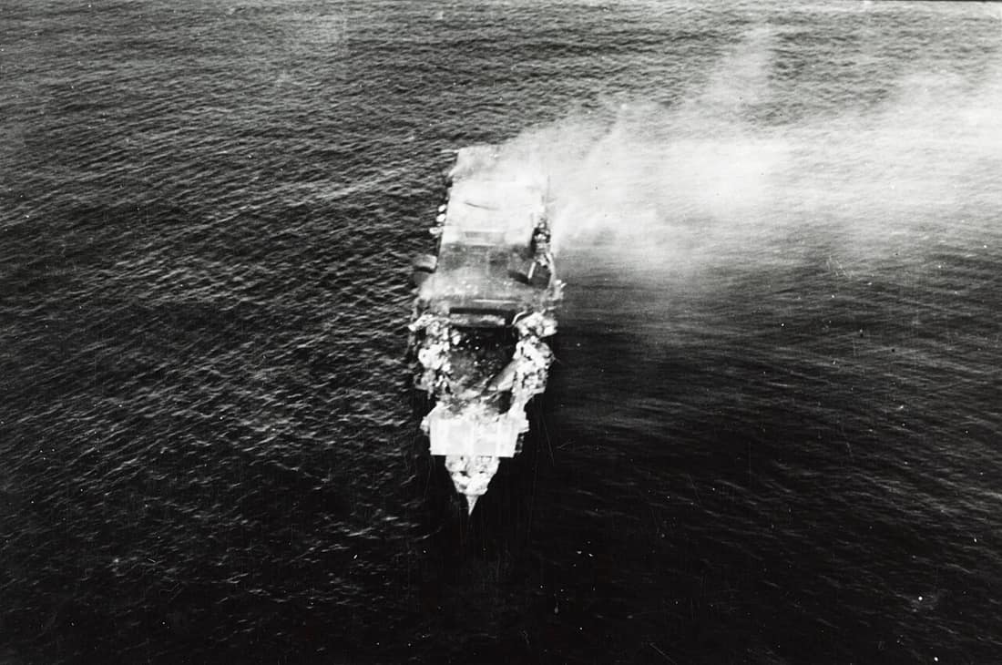 The burning Japanese aircraft carrier Hiryu, photographed by a Yokosuka B4Y aircraft from the carrier Hosho shortly after sunrise on 5 June 1942. Hiryu sank a few hours later. Flight deck torn out by the bomb dropped dur