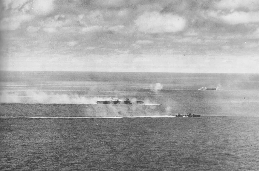 Imperial Japanese Navy aircraft carrier Zuikaku with Akizuki-class destroyer Wakatsuki underway during U.S. carrier plane attacks at about 1330 hrs. on 25 October 1944 during the Battle off Cape Engaño. The light carrier