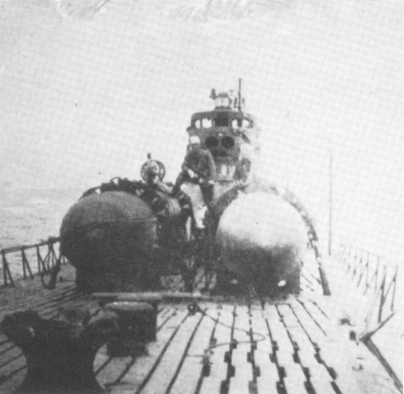 Kaitens (and a pilot) stacked upon their host C2 class submarine while at sea. This could very well be the I-53, although no markings are visible and it would take a real expert to identify from this image alone.