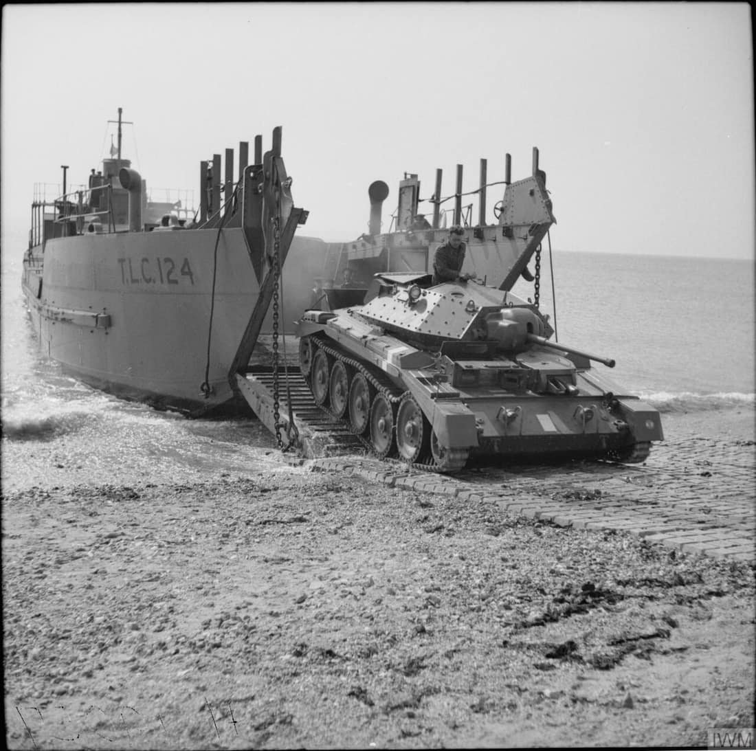 The British Army in the United Kingdom 1939-45 A Crusader I tank emerges from a tank landing craft (TLC 124) during tests of a portable concrete roadway, in this case laid on the beach, 26 April 1942.