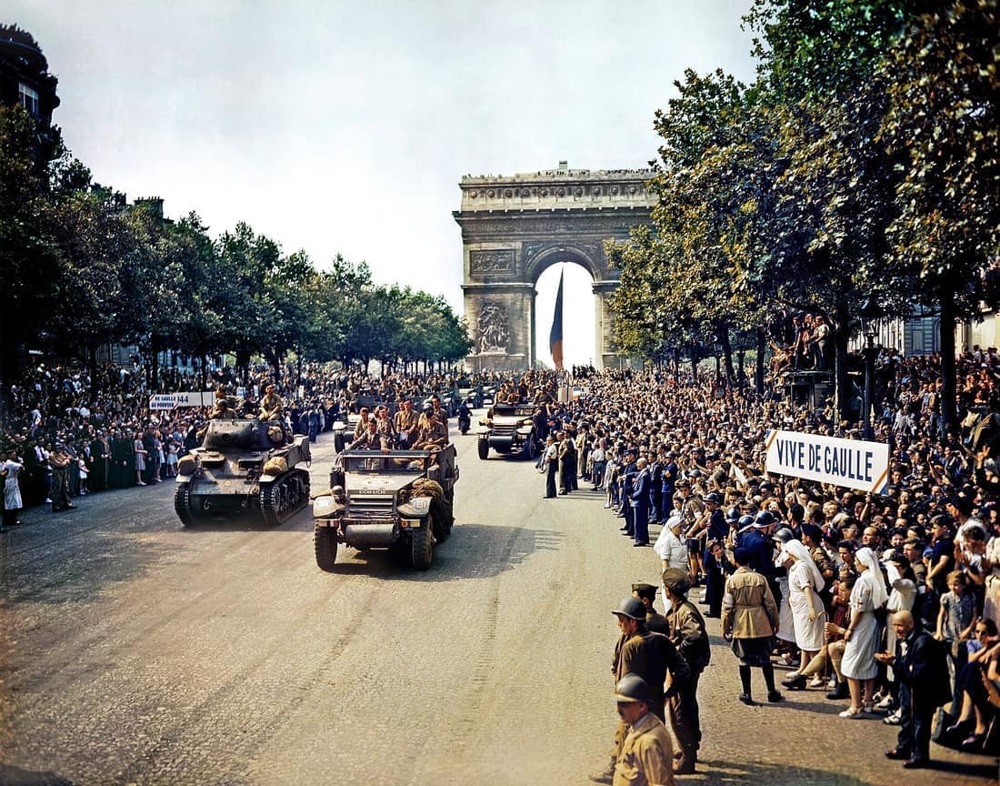 Crowds of French patriots line the Champs Elysees to view Free French tanks and half tracks of General Leclerc's 2nd Armored Division passes through the Arc du Triomphe, after Paris was liberated on August 26, 1944. Amon