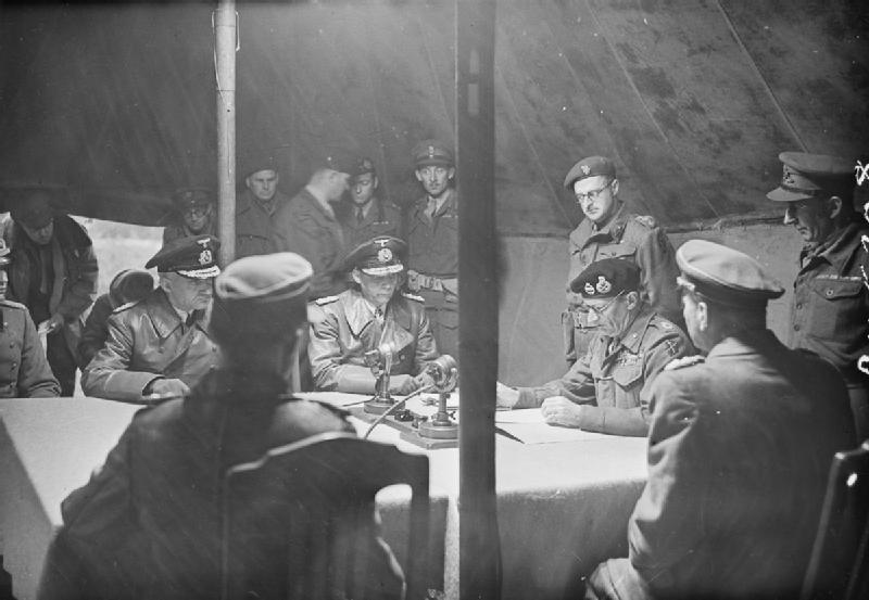 Field Marshal Bernard Montgomery reading the terms of the Instrument of Surrender of the German Armies in the northern part of Germany at Lüneberg Heath „Timeloberg“.