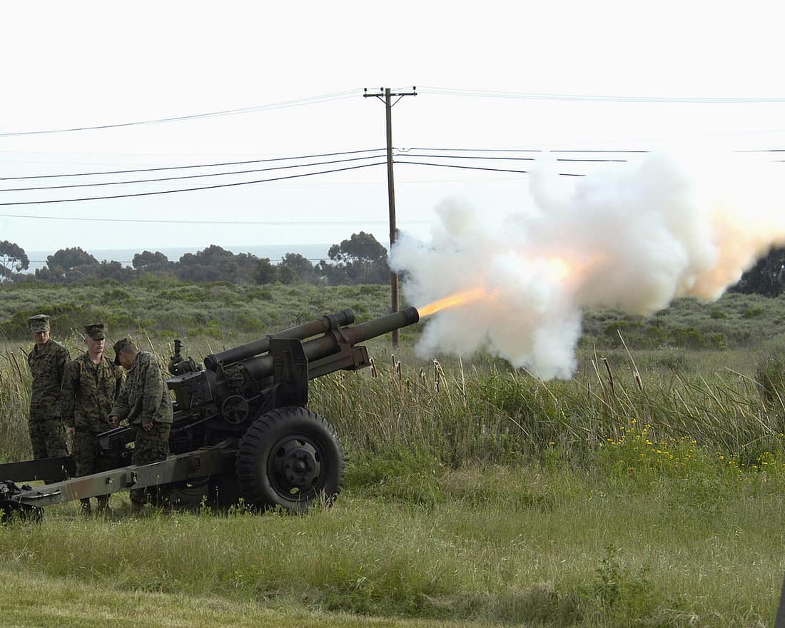 Marines from 11th Marines, 1st Marine Division fire a M101 105 mm Howitzer during the playing of taps at the Iwo Jima 60th Anniversary Commemorative on 26 March 2005. Camp Pendleton, California.