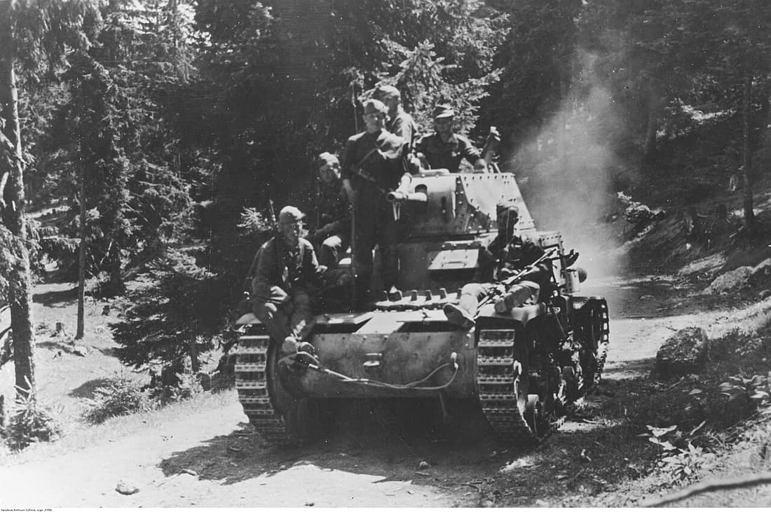 Waffen-SS panzergrenadiers atop an Italian M 14/41 tank driving through a forest road in pursuit of partisans in the mountains of Bosnia, August 1944.