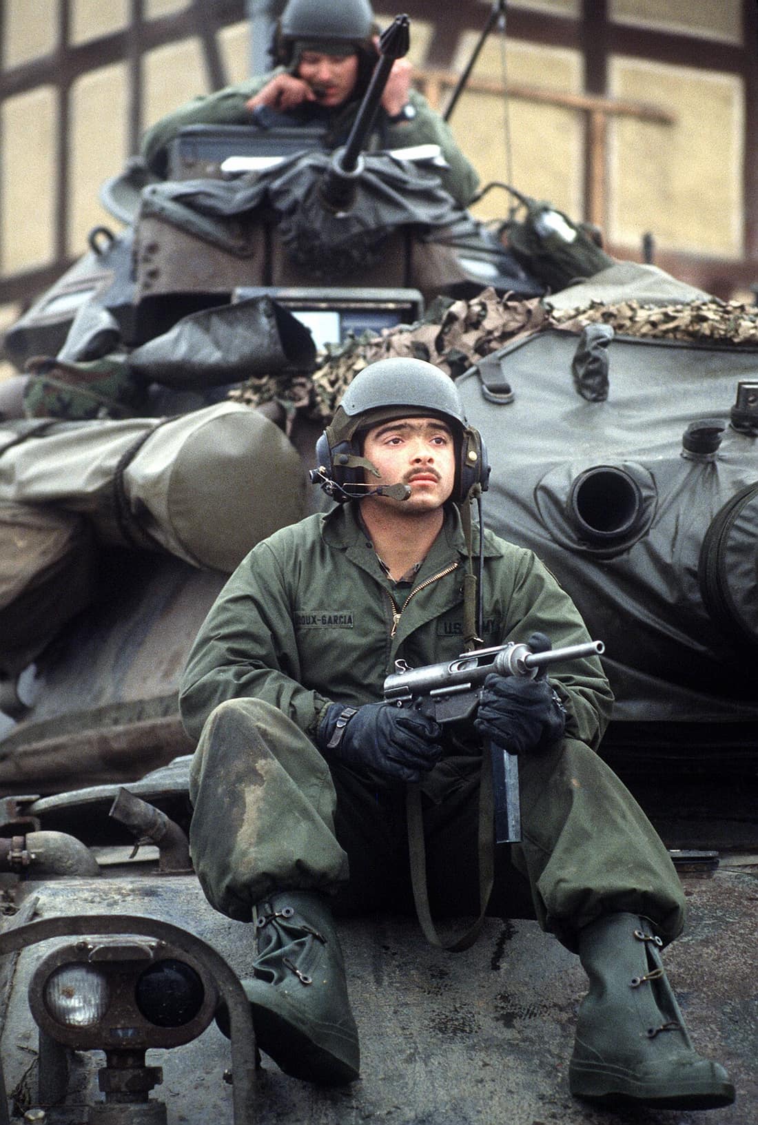 DF-ST-85-13234 - Private First Class (PFC) Jose Ledoux-Garcia of Company C, 5th Battalion, 77th Armor, guards his M60A3 main battle tank during Central Guardian, a phase of Exercise REFORGER '85. He is armed with an M3A1