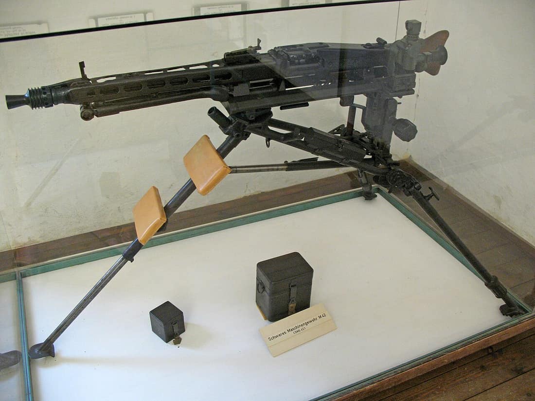 The MG 42 machine gun mounted on the Lafette 42 tripod with an optical sight mounted to the Zielfernrohrhalter (optical sight mounting bracket) on the tripod. This setup was used to enable the MG 42 for long-range direct
