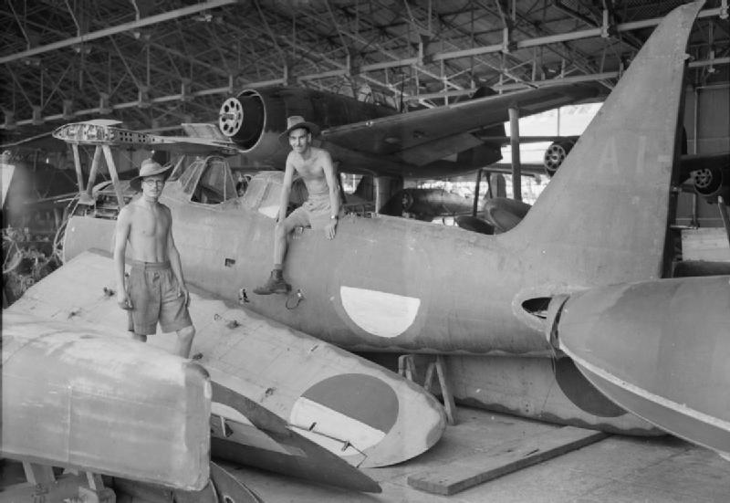 Corporal Ralph Hayden and Leading Aircraftman Harry Pearce of No. 80 Squadron RAF amongst parts of a Mitsubishi F1M, bearing Indonesian markings, at an airfield and seaplane base in Surabaya (Soerabaja), Java, January 19