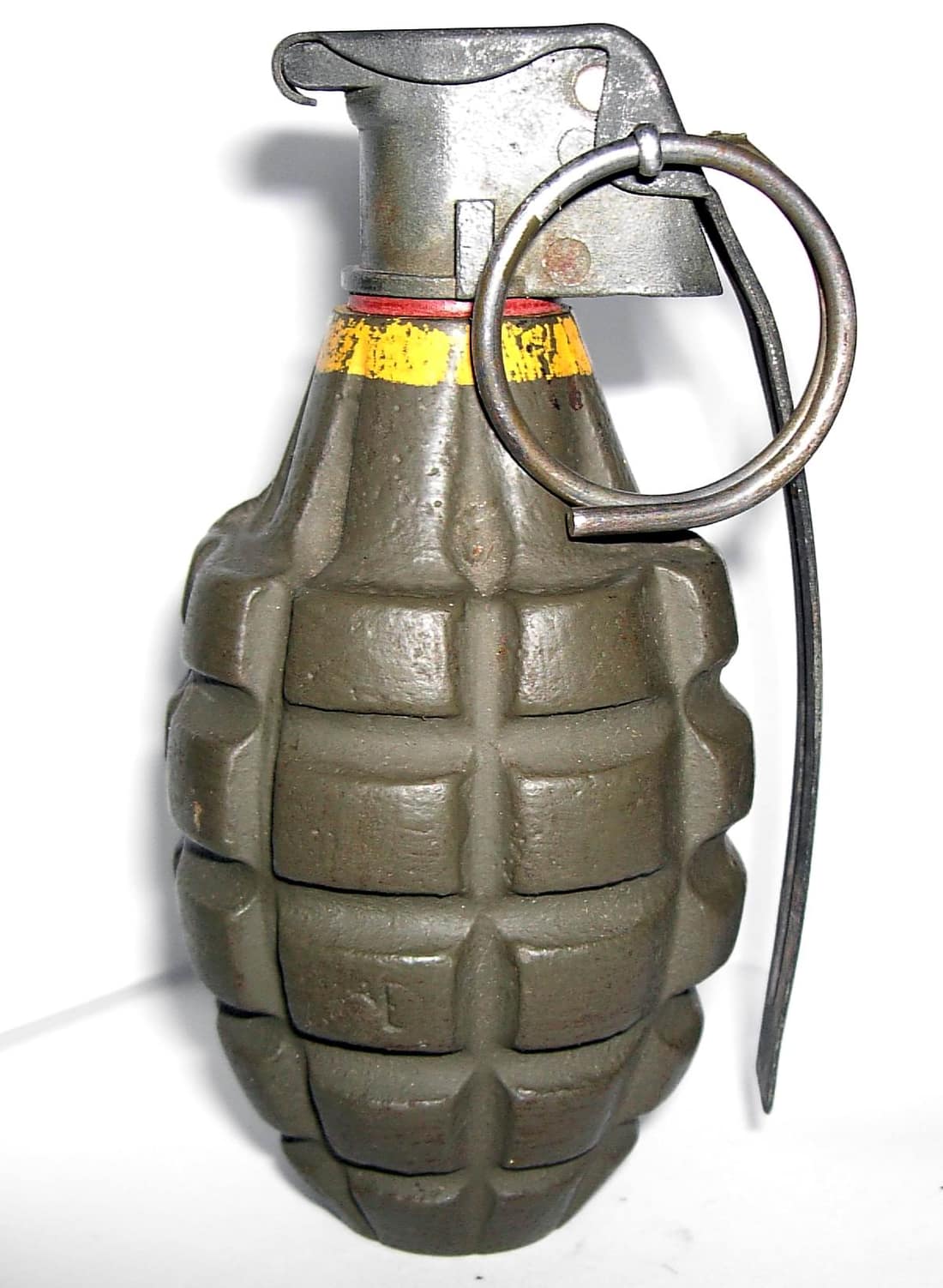 Side view of a yellow Mk II-A1 grenade, dating from World War II. It is mounted with the M10A3 series fuse assembly.