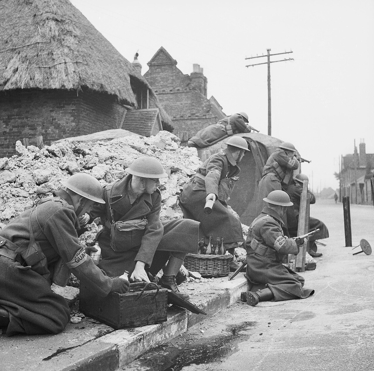 A squad of Home Guard soldiers training to defend a street with 'Molotov cocktail' petrol bombs, March 1941. The Home Guard: A squad of Home Guards prepare to deal with an invader by means of Molotov cocktails during tra