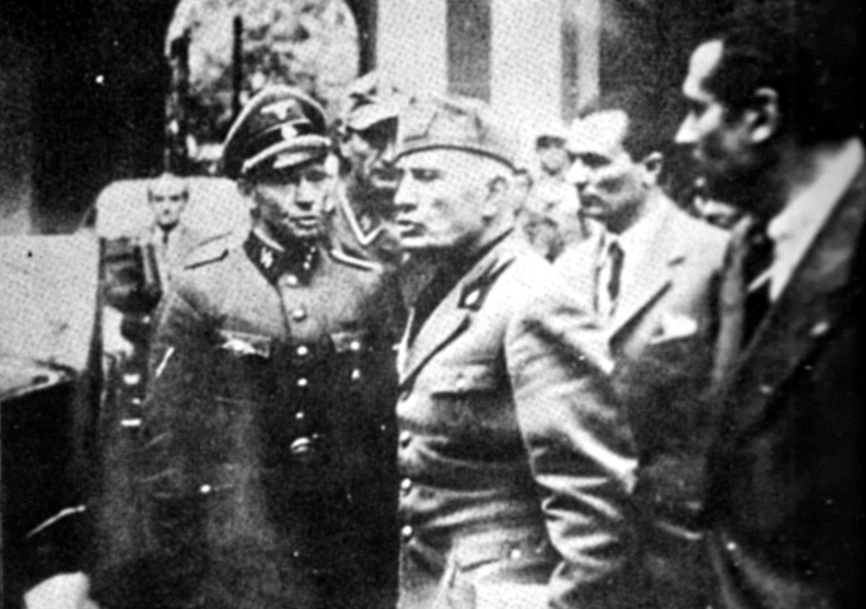 "The last photograph of Mussolini alive, taken during the late afternoon of April 25, 1945 , as he returned to the Milan Prefecture from a meeting at the Archbishop's residence with Cardinal Schuster." Photograph caption