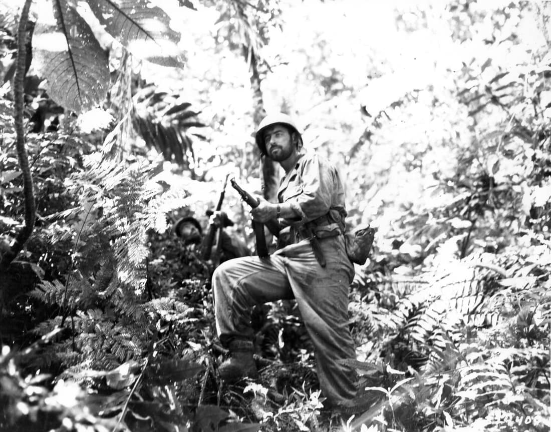 Men of the weapons platoon of Company K, 3rd Battalion, 27th Regiment, United States 25th Infantry Division, push through the jungle along the Zieta Trail during the battle of New Georgia on 12 August 1943