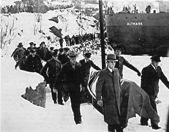 Flag-draped coffins containing German dead are brought ashore for burial after the Altmark Incident in Jøssingfjord, Norway.
