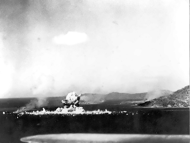 Japanese ammunition ship Aikoku Maru explodes following a torpedo attack by a US carrier based plane. The pilot and two crewmembers of this plane are presumed to be lost since their plane were caught in this terrific exp
