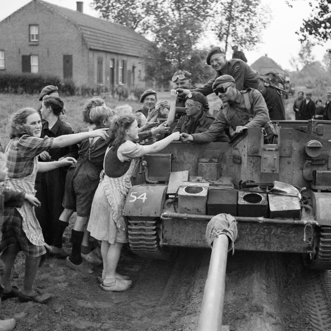 A carrier crew of 8th Rifle Brigade hands out chocolate to Dutch civilians during the advance of 11th Armoured Division in Holland, 22 September 1944. A carrier crew of 8th Rifle Brigade hands out chocolate to Dutch civi