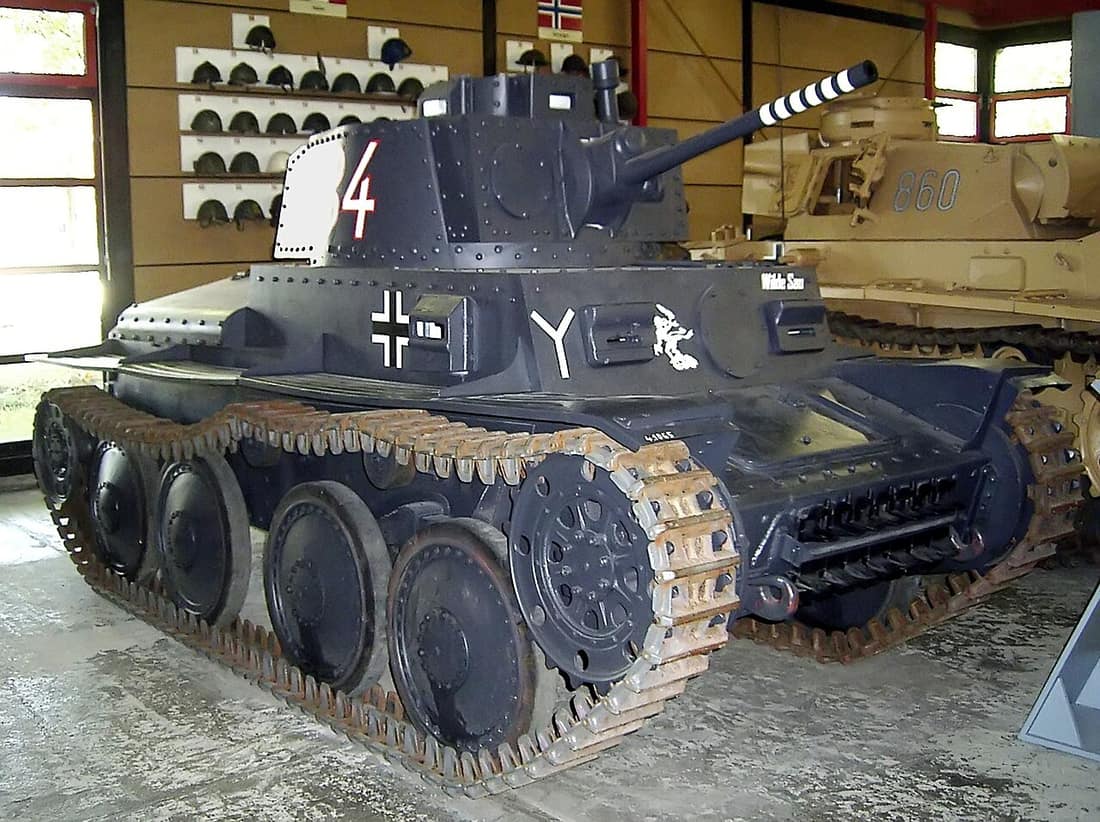 Deutscher Panzer 38(t) Ausführung S im Deutschen Panzermuseum Munster. The "Y"-like and ghost designs are emblems of 7th Panzer Division. Numbering on the side of the turret identifies the tank. Colored rings around the 